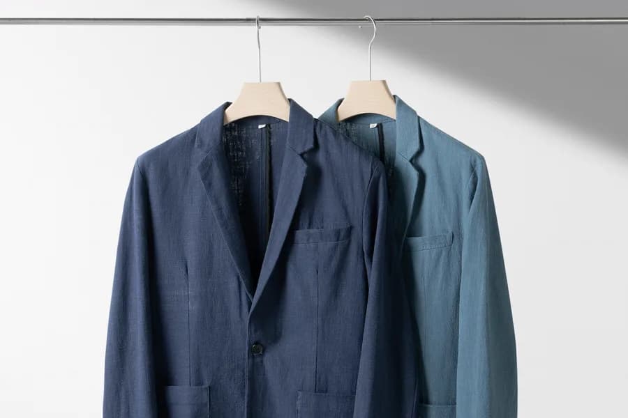 Navy uniform blazers on hangers